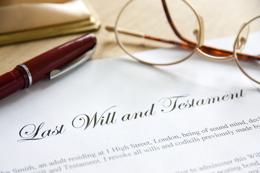 Last will and testament with glasses and pen