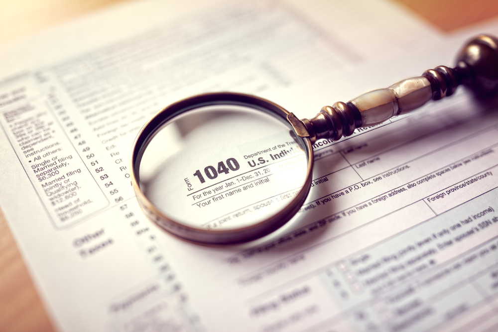 Magnifying glass over tax return